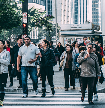 People walking across a city street.