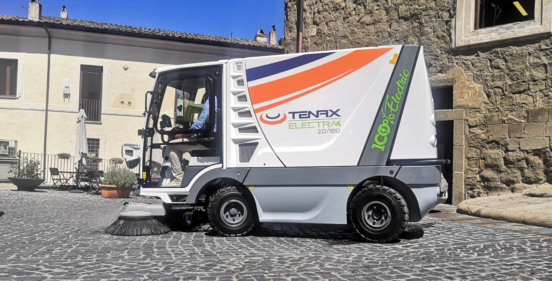 MaxWind Electric Sweeper cleaning cobble stone street.